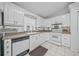 White kitchen with stainless steel appliances and plenty of counter space at 13027 Ne 7Th Loop, Silver Springs, FL 34488