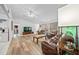 Open living area with high ceiling, leather furniture and LVP flooring at 13027 Ne 7Th Loop, Silver Springs, FL 34488