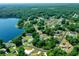Aerial view showing home on lakefront lot with mature trees and landscaping at 13027 Ne 7Th Loop, Silver Springs, FL 34488