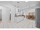 Open kitchen with white cabinets, stainless steel appliances and breakfast bar at 13027 Ne 7Th Loop, Silver Springs, FL 34488