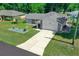 Single-story home with a large driveway and landscaped front yard at 13027 Ne 7Th Loop, Silver Springs, FL 34488