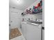 Laundry room with washer, dryer, and extra storage shelves at 13027 Ne 7Th Loop, Silver Springs, FL 34488