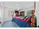 Spacious bedroom with a wooden bed frame and large TV at 13027 Ne 7Th Loop, Silver Springs, FL 34488