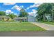 House exterior with a landscaped yard and attached garage at 13027 Ne 7Th Loop, Silver Springs, FL 34488