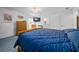 Main bedroom with large bed, dresser and relaxing chair at 13027 Ne 7Th Loop, Silver Springs, FL 34488