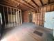 Under construction home interior with exposed wooden beams and hardwood floors at 208 E Badcock Blvd, Mulberry, FL 33860