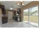 Modern kitchen with dark cabinets and sliding glass door at 247 Malauka Loop, Ocklawaha, FL 32179