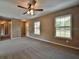 Bright living room with neutral walls, ceiling fan, and carpeted floors at 247 Malauka Loop, Ocklawaha, FL 32179