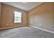 Spacious bedroom with carpeted floors and large window at 247 Malauka Loop, Ocklawaha, FL 32179