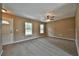 Bright living room with neutral walls, ceiling fan, and carpeted floors at 247 Malauka Loop, Ocklawaha, FL 32179