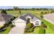 House exterior with a two-car garage and landscaping at 2003 Odessa Cir, The Villages, FL 32162