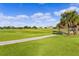 View of lush golf course with palm trees and homes at 2003 Odessa Cir, The Villages, FL 32162