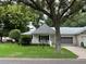 White single-story home with gray roof and lush landscaping at 8420 Sw 92Nd St # A, Ocala, FL 34481