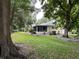 Backyard view showing a screened porch and mature trees at 8420 Sw 92Nd St # A, Ocala, FL 34481