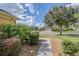 Landscaped yard with a walkway leading to the home at 9818 Sw 63Rd Loop, Ocala, FL 34481