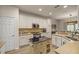 Modern kitchen with white cabinets, granite countertops, and a kitchen island at 9818 Sw 63Rd Loop, Ocala, FL 34481