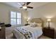 Well-lit bedroom with a queen-size bed and neutral decor at 9818 Sw 63Rd Loop, Ocala, FL 34481