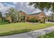 Single-story home with landscaped yard, palm trees, and a two-car garage at 9818 Sw 63Rd Loop, Ocala, FL 34481