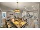 Open dining room with kitchen views and a large wooden table at 9818 Sw 63Rd Loop, Ocala, FL 34481