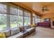 Sunroom with plenty of natural light and comfortable seating at 9818 Sw 63Rd Loop, Ocala, FL 34481