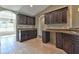 Dark wood kitchen cabinets with granite countertops at 7866 Sw 128Th Terrace Rd, Dunnellon, FL 34432