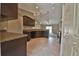 Modern kitchen with dark cabinets, granite counters, and tile floors at 7866 Sw 128Th Terrace Rd, Dunnellon, FL 34432