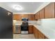 Kitchen with wood cabinets, stainless steel appliances, and wood-look floors at 2915 Sw 32Nd Ave # C3, Ocala, FL 34474