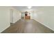 Open living room with wood-look floors and access to hallway and balcony at 2915 Sw 32Nd Ave # C3, Ocala, FL 34474