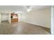 Living area with wood-look floors, ceiling fan, and kitchen bar at 2915 Sw 32Nd Ave # C3, Ocala, FL 34474