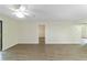 Living room with wood-look floors and access to adjacent room at 2915 Sw 32Nd Ave # C3, Ocala, FL 34474