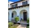 Two-story home with arched entryway and shutters at 8943 Lakeshore Pointe Drive, Winter Garden, FL 34787