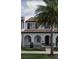 Two-story townhome with Spanish-style architecture, tile roof, and arched entryway at 8943 Lakeshore Pointe Drive, Winter Garden, FL 34787