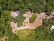 Aerial view of property showing home nestled in the woods at 14260 Ne 40Th Ct, Anthony, FL 32617