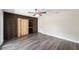 Bedroom with barn door closet and vinyl plank flooring at 14260 Ne 40Th Ct, Anthony, FL 32617