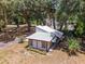 Aerial view of a small house with metal roof in wooded area at 14260 Ne 40Th Ct, Anthony, FL 32617