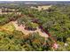 Aerial view of property showing home nestled in the woods at 14260 Ne 40Th Ct, Anthony, FL 32617
