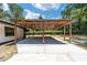 Open carport next to home with wood and metal roof at 14260 Ne 40Th Ct, Anthony, FL 32617