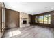 Spacious living room featuring a stone fireplace and large windows at 14260 Ne 40Th Ct, Anthony, FL 32617