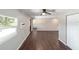 Bright living room featuring dark laminate flooring and ceiling fan at 14260 Ne 40Th Ct, Anthony, FL 32617