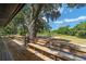 Wooden deck with built-in benches, overlooking a grassy area at 14260 Ne 40Th Ct, Anthony, FL 32617