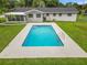 Inviting rectangular pool with a concrete deck and surrounding grass at 3204 Se 34Th St, Ocala, FL 34471