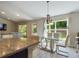 Elegant dining area with a glass table and ample natural light at 3962 Ne 58Th Cir, Silver Springs, FL 34488