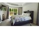 Spacious bedroom with a comfortable bed and large window at 3962 Ne 58Th Cir, Silver Springs, FL 34488