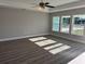 Living room with vinyl plank flooring, neutral walls, and ceiling fan at 73 Juniper Trail Loop, Ocala, FL 34480