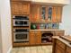 Modern kitchen featuring wood cabinets, double ovens, and granite countertops at 56633 Otter Rd, Astor, FL 32102