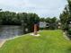 Miniature lighthouse and lush lawn by the river at 56633 Otter Rd, Astor, FL 32102