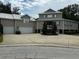 Two-story house with a three-car garage and a landscaped yard at 56633 Otter Rd, Astor, FL 32102