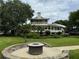 Relaxing patio area with fire pit and view of the house at 56633 Otter Rd, Astor, FL 32102