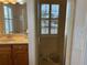 Bathroom with a walk-in shower, double vanity, and marble countertop at 56633 Otter Rd, Astor, FL 32102