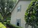 Tan house exterior with shutters, and landscaping at 56633 Otter Rd, Astor, FL 32102
